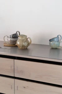Scandinavian Tenon wood kitchen with Brandt ceramics decor, featuring natural wood cabinetry, exposed tenon joinery, and ceramic accents